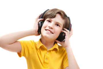 Happy boy listens music with headphones, isolated on white