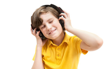 Happy boy listens music with headphones, isolated on white