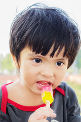 Asian Thai little boy eating ice cream