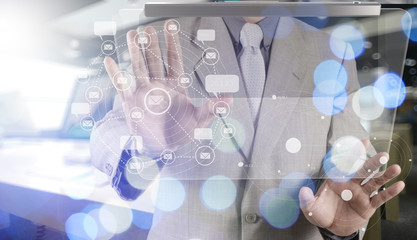 Double exposure of businessman shows modern technology as concep