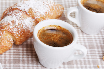 Cups of coffee with croissant