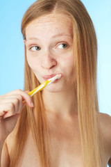 Woman brushing teeth