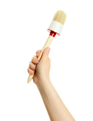Brush in hand on white background.