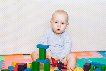 Cute little baby playing with colorful toys