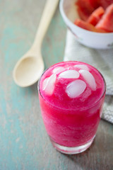 A glass of strawberry smoothie with sugar palm fruit