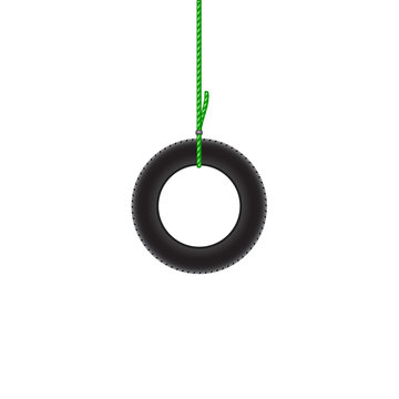 Car tire hanging on green rope