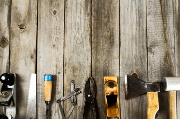 Many working tools on a wooden background.