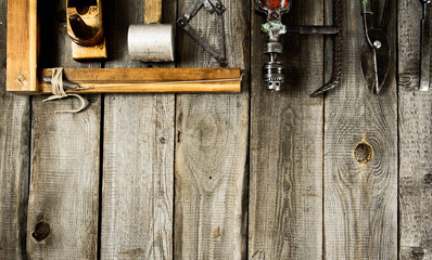 Many working tools on a wooden background.