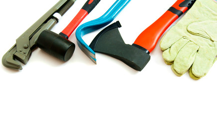 Many working tools - axe, glove and others on white background.