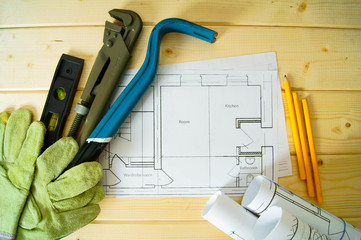 House construction. Drawings for building, wrench, gloves and