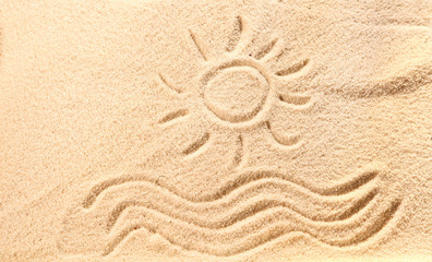 Fototapeta na wymiar Drawing of waves and sun on beach sand