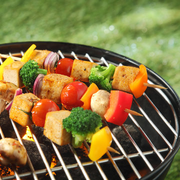Tofu skewers grilling on a barbecue