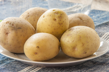 Potatoes on white plate close up