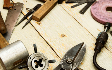 Vintage working tools on wooden background.