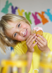 Happy little boy eat cupcake