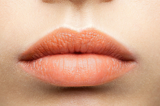 Matte peach-colored lips