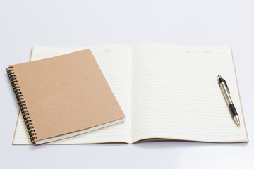 Blank notebook with a pen on white table