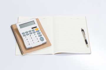 Blank notebook with office accessories on white table
