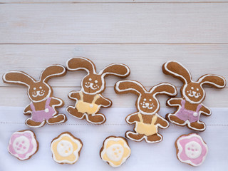 Four Easter Bunny and flower shaped cookies on the white wooden