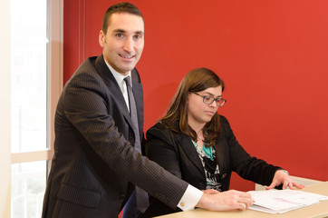 Two co-workers discussing business plan in office
