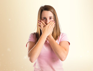 Young girl doing surprise gesture over white background