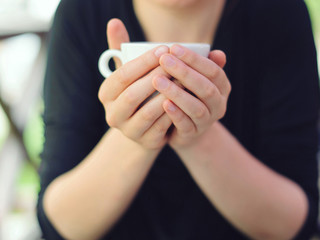 White Cup in Hands