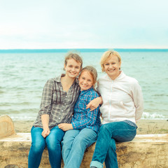 Fototapeta na wymiar mother and her two daughters on the shore