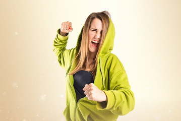 Girl giving punch over isolated white background