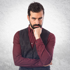 Man wearing waistcoat thinking