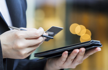 Business woman are shopping online by using mobile phone and cre