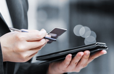 Business woman are shopping online by using mobile phone and cre