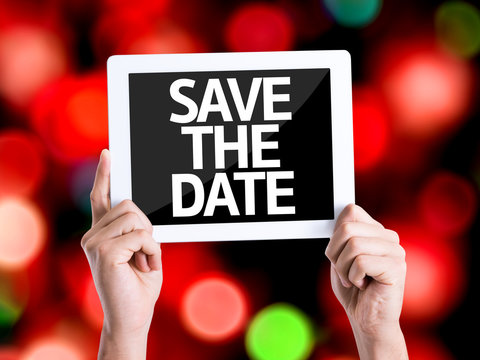 Tablet pc with text Save the Date with bokeh background