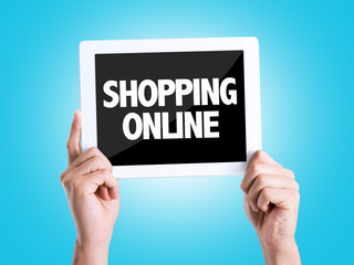 Tablet pc with text Shopping Online with blue background