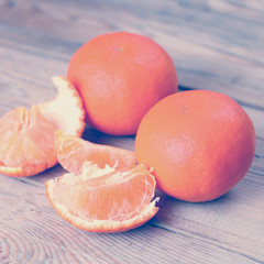 Orange tangerines on a wooden background