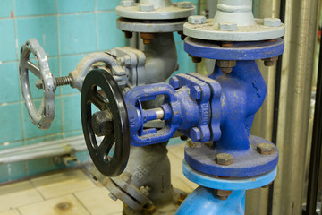 Pipes and faucet valves of heating system in a boiler room