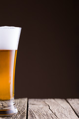 Beer glass in a golden background.