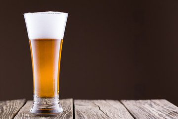 Beer glass in a golden background.