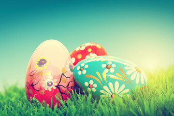 Handmade Easter eggs on grass. Spring patterns, unique.