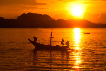 Sunset at traditional fishing boat in Koh Phitak island.