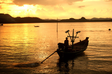 Sunset at traditional fishing boat in Koh Phitak island.