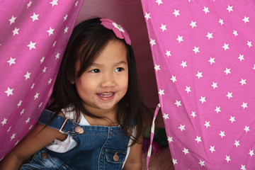 Asian toddler smiling and playing
