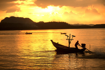 Sunset at traditional fishing boat in Koh Phitak island.