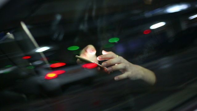 Young attractive woman using mobile phone in the car