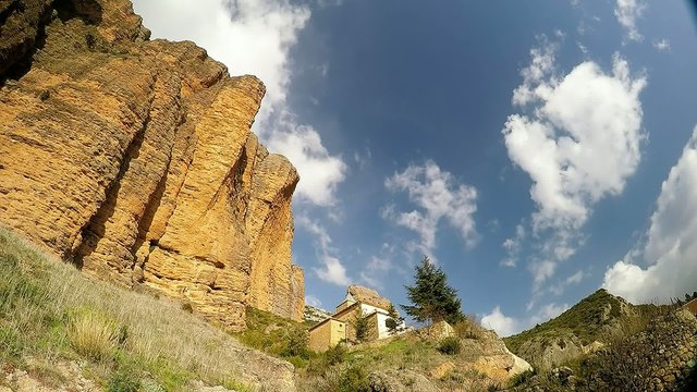 time lapse of a big cliff with small monastery in the village