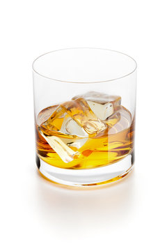 Glass of whiskey with ice isolated on white.
