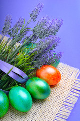 Easter marble green and orange eggs with lavender.
