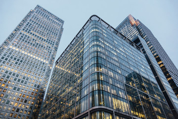 Naklejka premium Modern skyscrapers in London at sunset, bottom view.