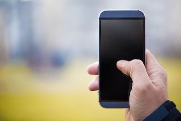 Man Holding Smartphone Against Green Background
