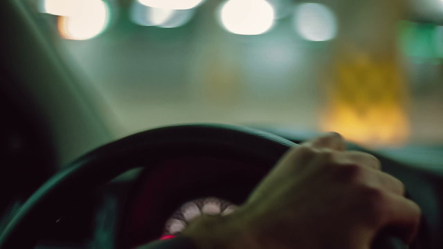 Hands of a man driving a car. Close up