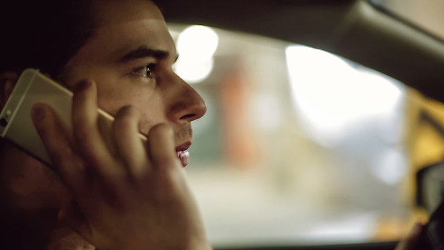 A man driving car and speaking on mobile phone